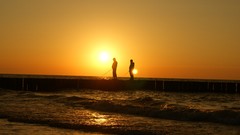 Sunset Sea fishermen waves