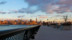 Sunset water sidewalks fences cityscapes new york city towns