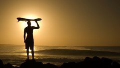 Sunset waves silhouettes surfing