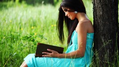 Trees grass woman Books thoughtful outdoors smiling
