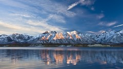 Water Mountains clouds sky light surface ripples ridge