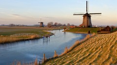 Winter windmills ice skaters frozen river