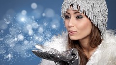 Winter woman gloves studio portraits blowing a kiss