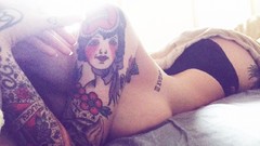 Woman ass tattoos lying down suicide girls