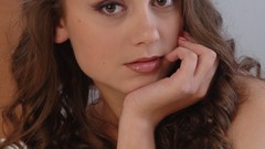 Woman beds faces brunettes lying down pink clothing. daniella