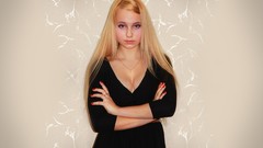 Woman blondes long hair black dress cleavage decollete