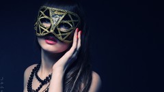 Woman blue background long hair necklaces Venetian masks