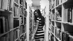 Woman Books Library monochrome Shelves smiling long hair 