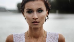 Woman brunettes lip gloss in the rain