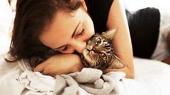 Woman cats tabby hugging closed eyes