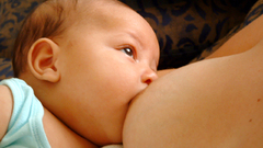 Woman close-up baby breastfeeding