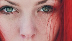Woman close-up faces green eyes freckles redheads finger on 