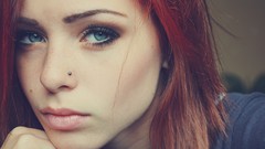 Woman close-up faces green eyes piercings redheads pale skin 