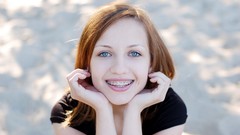 Woman faces smiling blue eyes models braces redheads