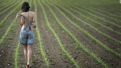 Woman fields outdoors barefoot Overalls undressing farms