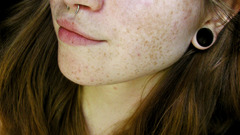 Woman freckles piercings nose