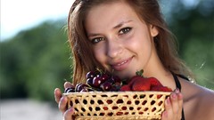 Woman fruits bowl outdoors smiling long hair brown eyes 