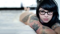 Woman glasses tattoos radeo piercings black hair