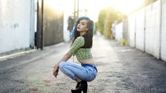 Woman jeans bokeh sunlight blue hair dyed high heels pale skin 