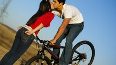 Woman kissing mtb stoppie Stoopie to kiss Trek bike