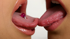 Woman kissing pierced tongue
