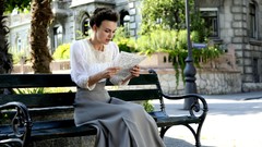 Woman letters Plants bench Keira Knightley reading blurred 