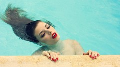Woman lips nails wet hair swimming pools