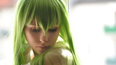 Woman models green hair cosplay priestess Shizuka i am