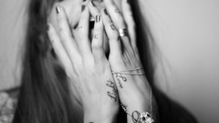 Woman monochrome tattoos models hands on face annina roescheisen