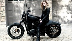 Woman motorbikes black bike