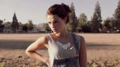 Woman outdoors hands on back