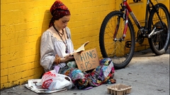 Woman reading homeless person