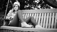 Woman swings hats greyscale