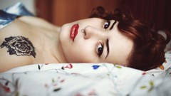 Woman tattoos lying down redheads nose ring
