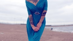 Woman tattoos piercings models nipples through clothing 