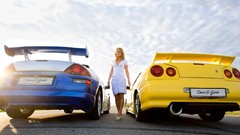 Woman tuning cars low-angle shot Nissan Skyline R34 GT-R 