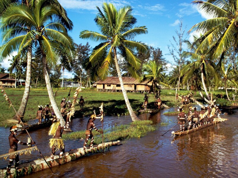 Indigenous people in traditional canoes