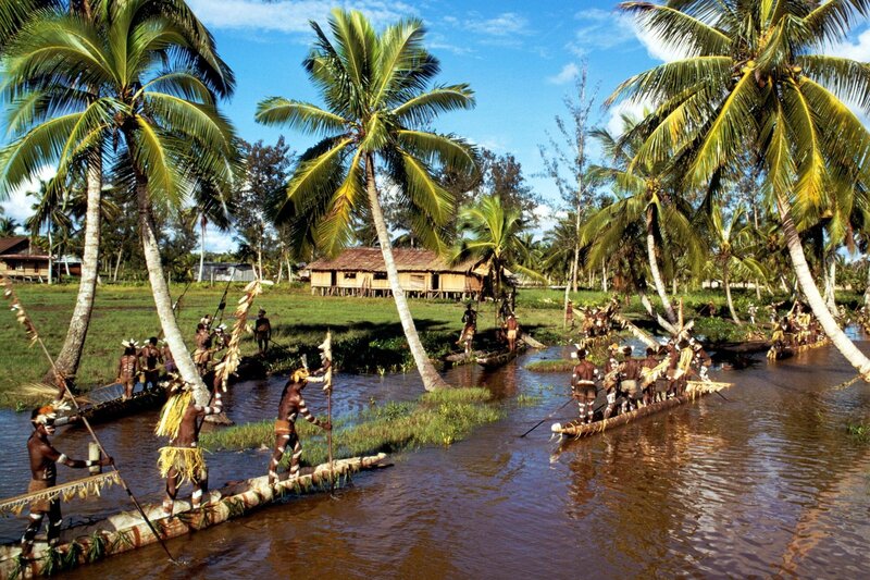Indigenous people in traditional canoes