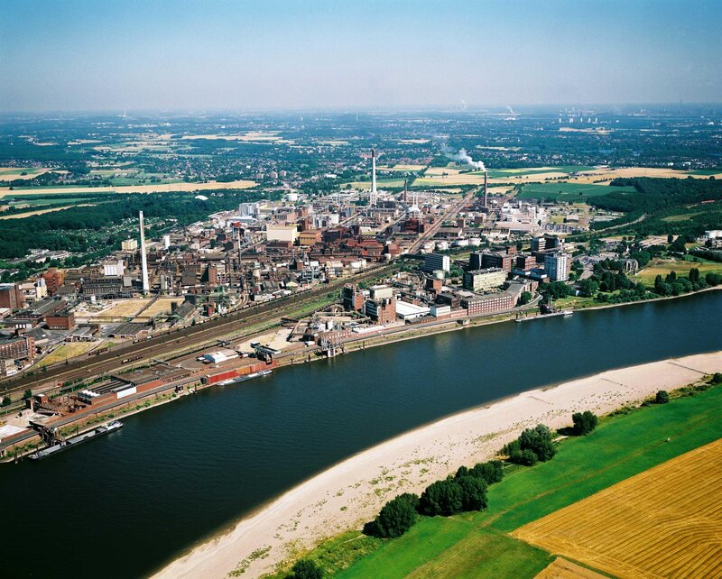 Industrial Complex by River — Blue