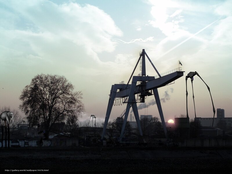 Industrial cranes at sunset