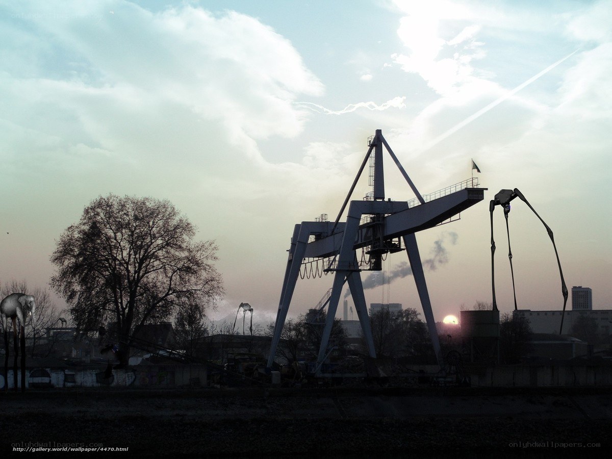 Industrial cranes at sunset