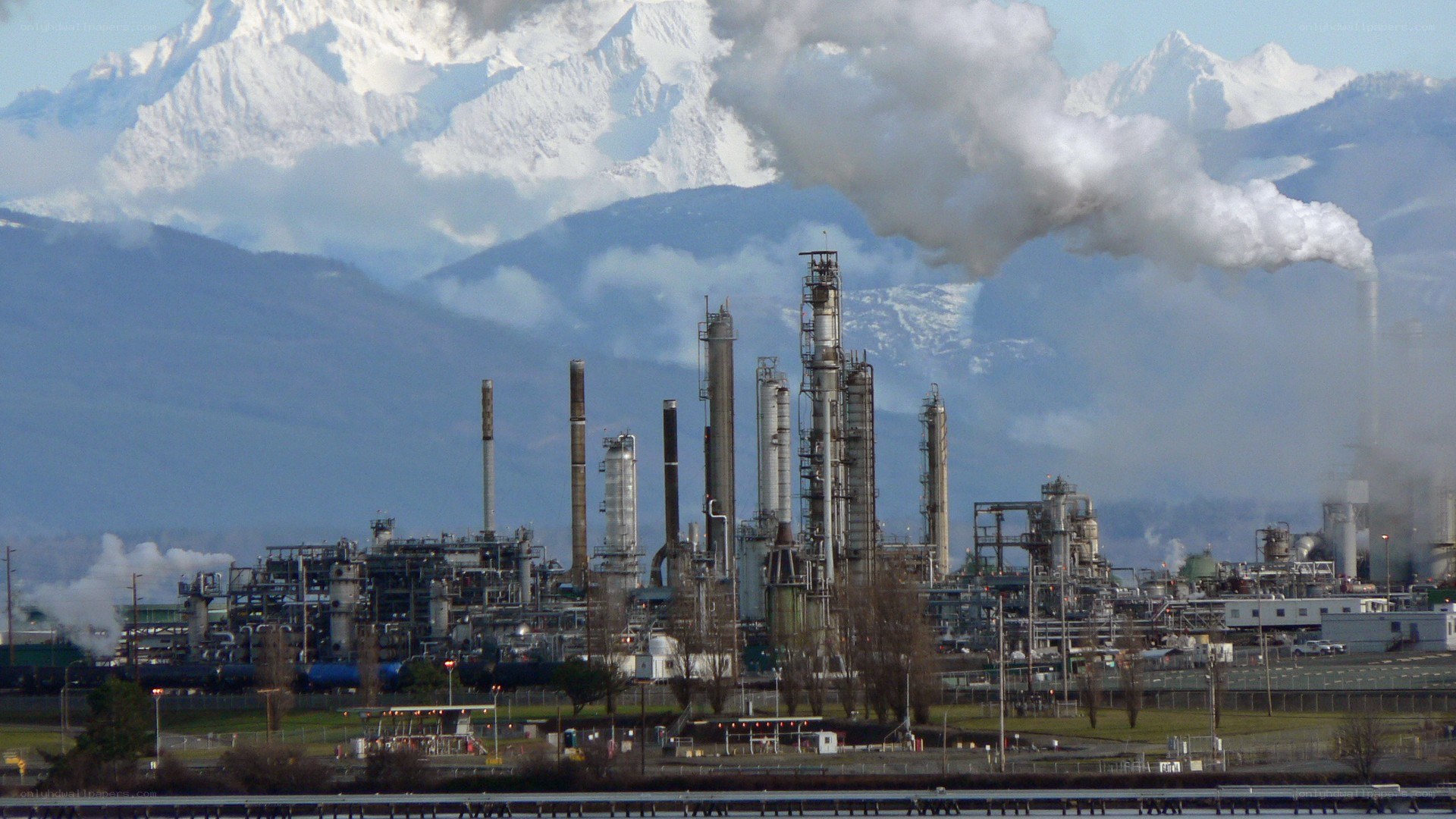 Industrial plant with mountain backdrop