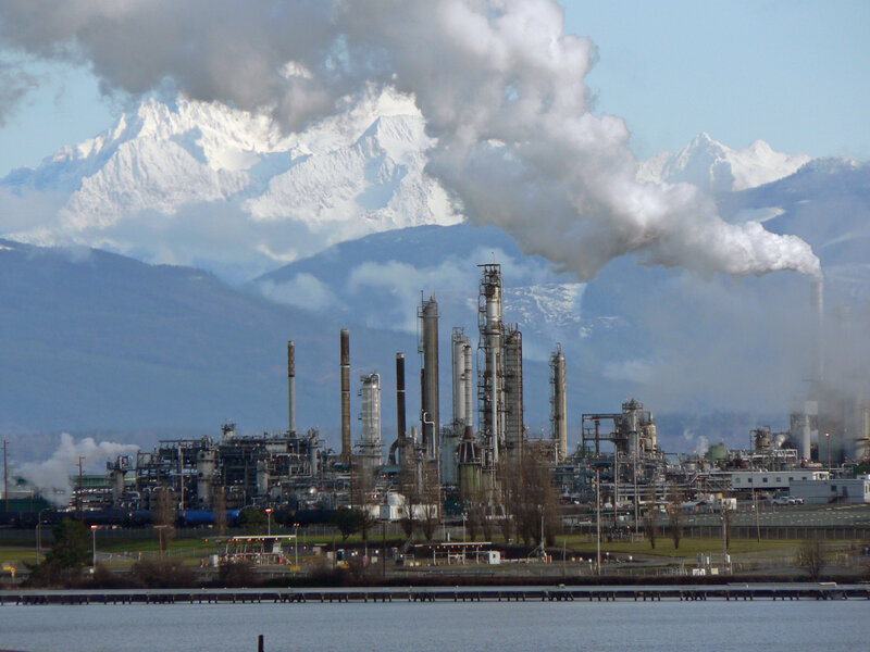 Industrial plant with mountain backdrop