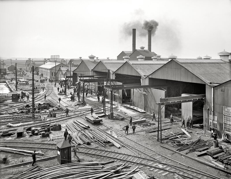 Industrial rail yard with smokestacks