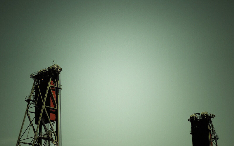 Industrial towers against sky