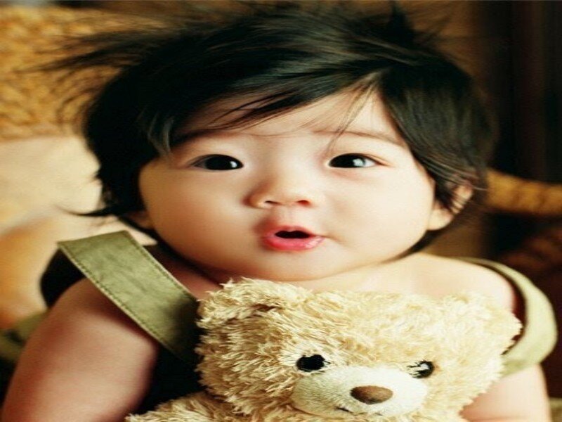 Infant Holding Teddy Bear