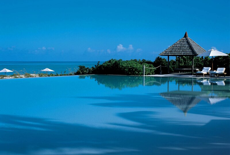 Infinity Pool at Beach — Blue, Serene, Afternoon, Photograph, Umbrella