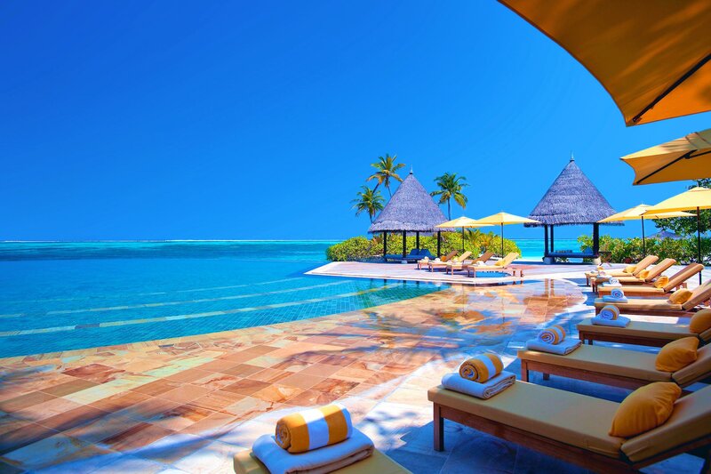Infinity Pool at Resort — Blue, Serene, Afternoon, Photograph, Lounge Chairs, Umbrellas