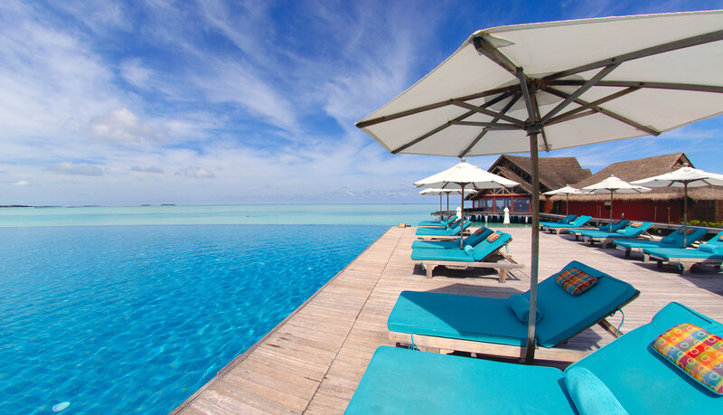 Infinity Pool at Resort — Blue, Serene, Afternoon, Photograph, Loungers
