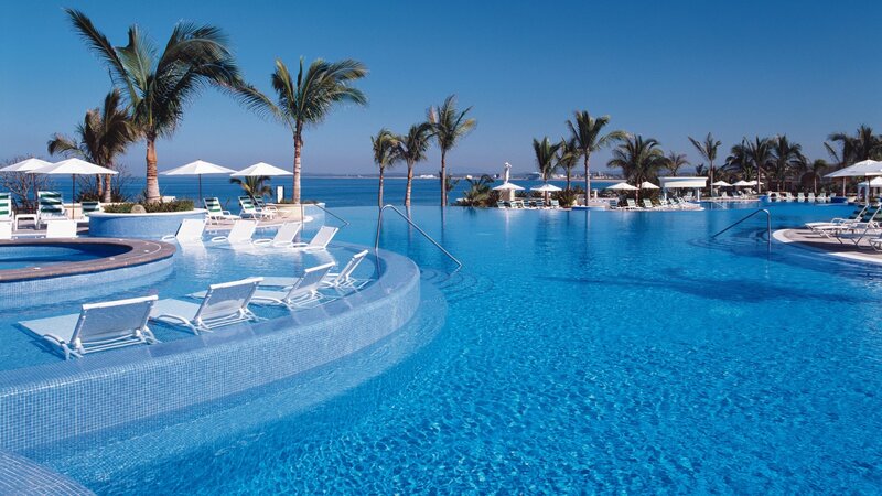 Infinity Pool at Resort — Blue, Serene, Afternoon, Photograph, Palm Trees, Lounge Chairs